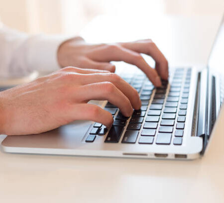 Man using laptop on table Man using laptop on table